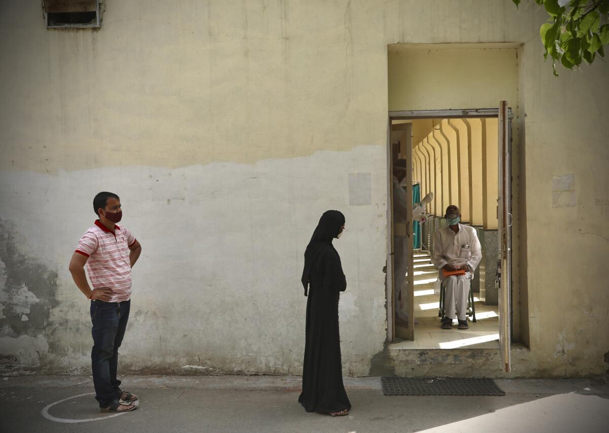 People waiting for COVID-19 vaccinations in New Delhi