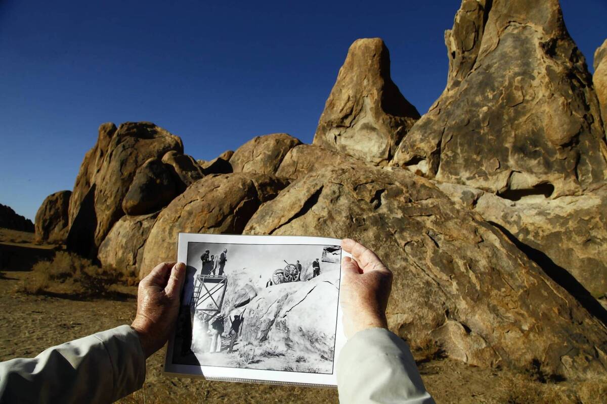 Kent Sperring matches a cannon emplacement and camera platform in a still photograph from the 1936 John Wayne movie "The Oregon Trail," shot in and around the Alabama Hills near Lone Pine.