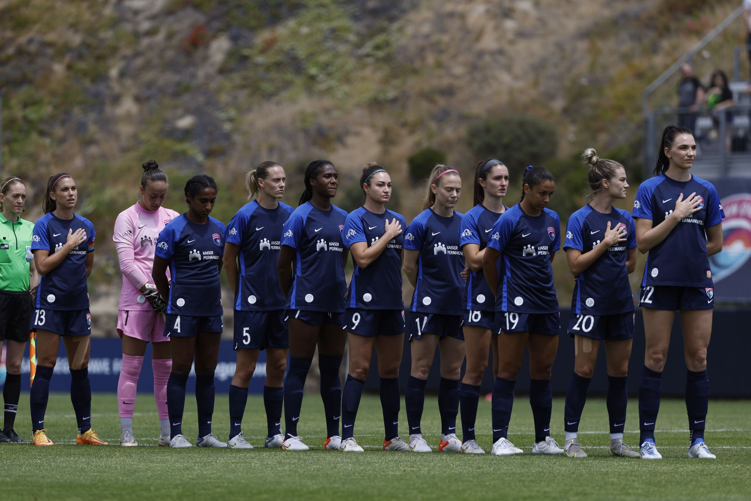 The San Diego Wave FC stand for the national anthem before a game against the Chicago Red Stars on Sunday, May 15, 2022.