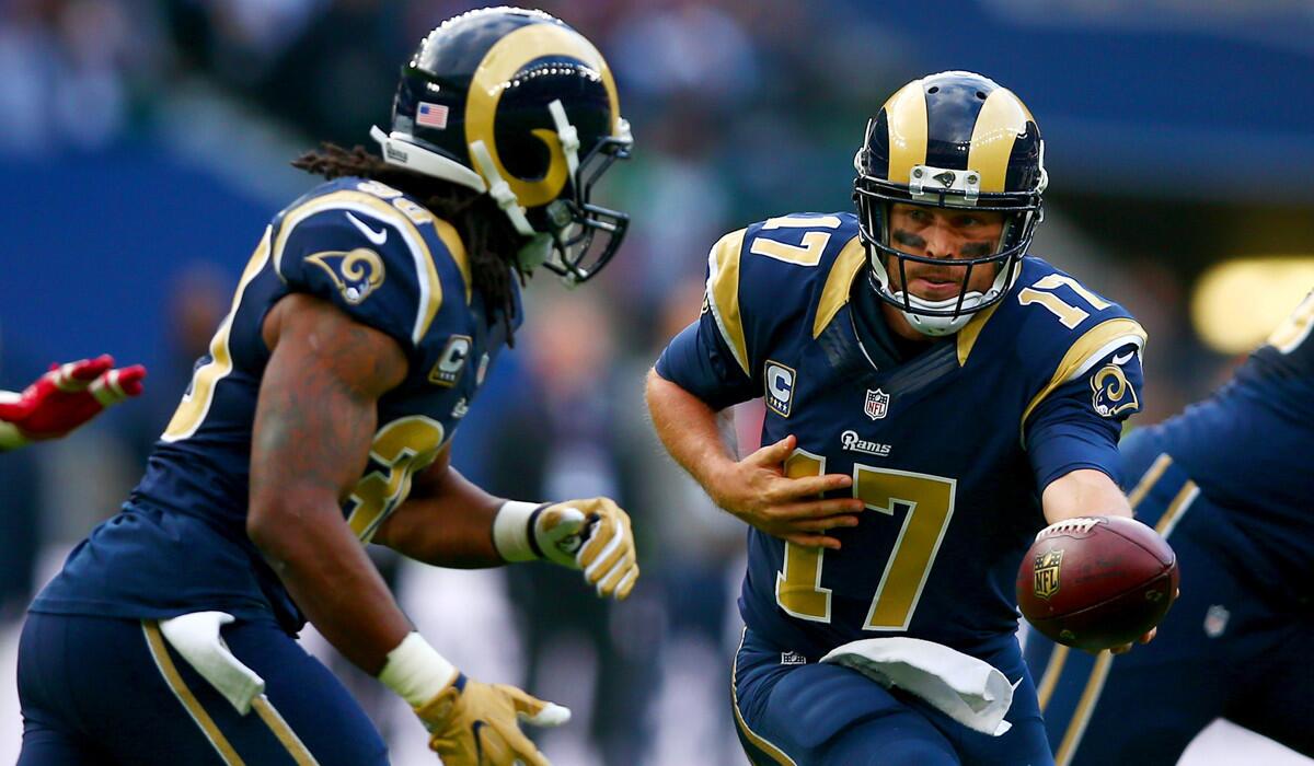 Rams quarterback Case Keenum hands off to running back Todd Gurley during their loss to the Giants in London.