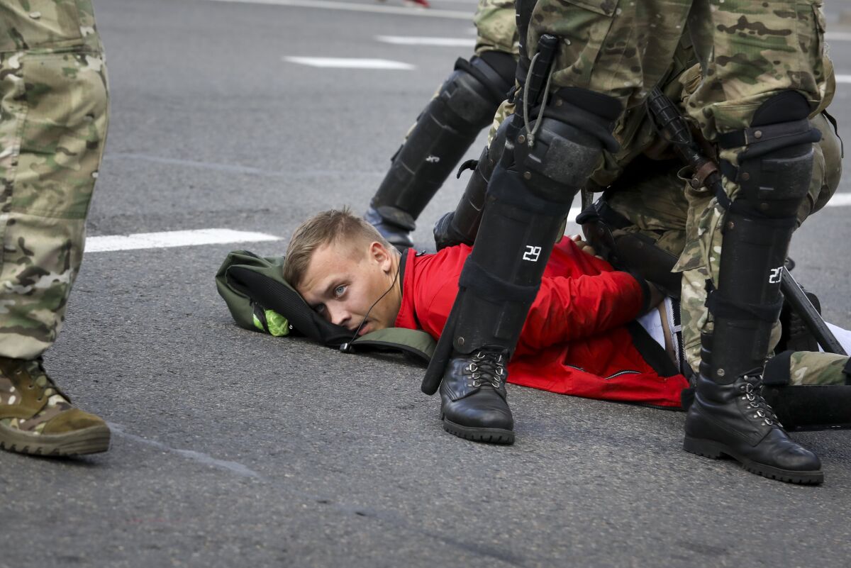 Riot police officers detain a protester during a Belarusian opposition supporters' rally protesting the official presidential election results in Minsk, Belarus, Sunday, Sept. 13, 2020. Protests calling for the Belarusian president's resignation have broken out daily since the Aug. 9 presidential election that officials say handed him a sixth term in office. (AP Photo)
