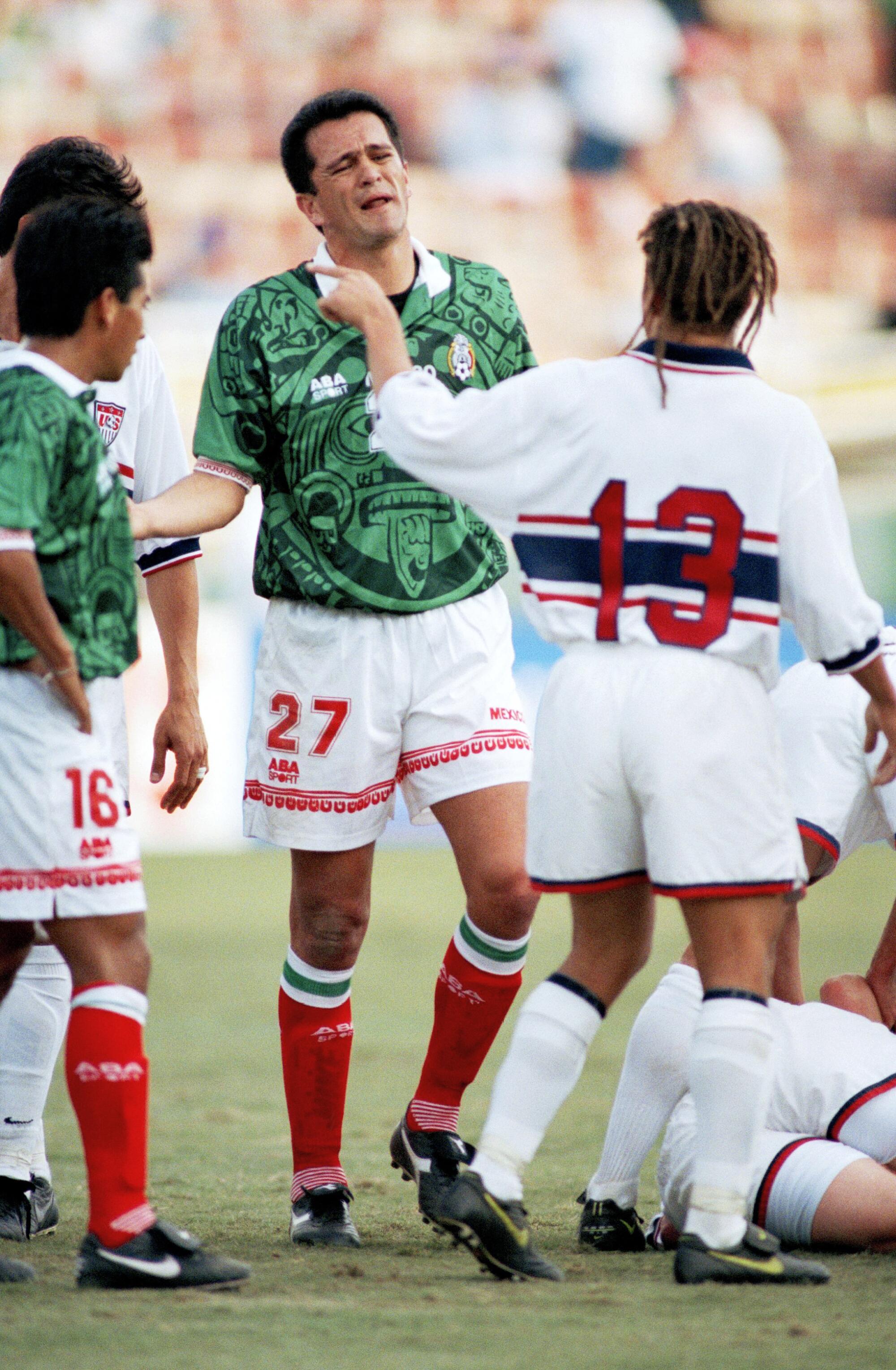 United State’s Cobi Jones (13) argues with