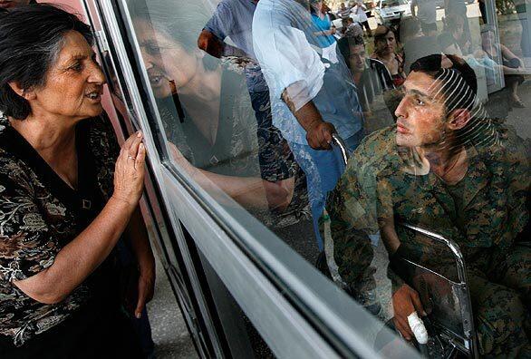 Giorgi Ramazahshvili, 21, was one of 13 Georgian prisoners and two civilians who were exchanged for five Russian prisoners on Aug. 19. He greets a relative after arriving at the Ghudushauri Hospital in Tbilisi, the Georgian capital. Ramazahshvili was taken prisoner near Gori which the Russians now occupy.