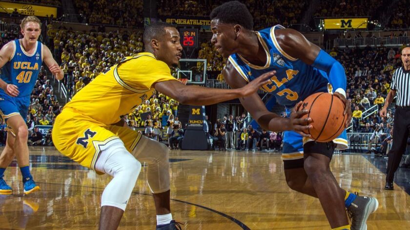 Michigan guard Muhammad-Ali Abdur-Rahkman, left, defends UCLA guard Aaron Holiday in the first half on Saturday in Ann Arbor, Mich.