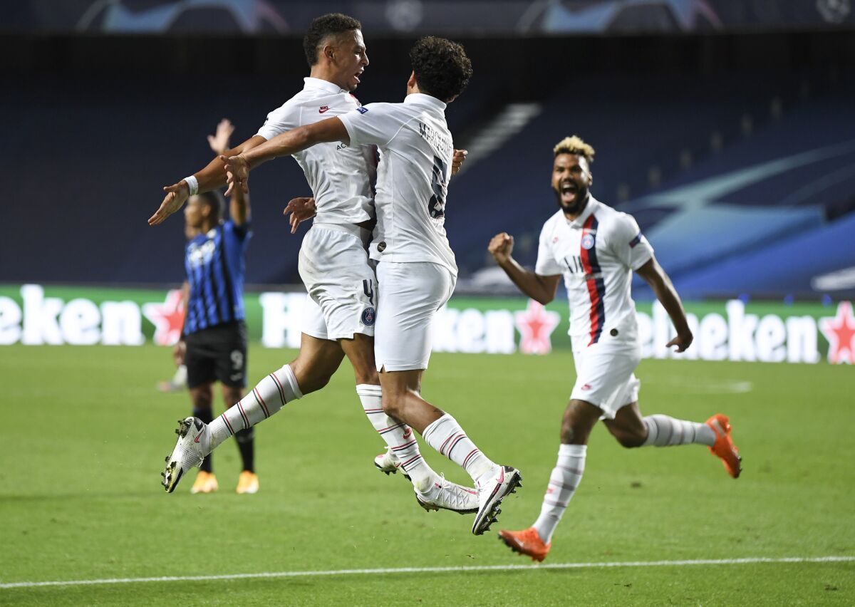 PSG's Marquinhos, centre, celebrates with teammate Thilo Kehrer, left, after scoring his team's first goal during the Champions League quarterfinal match between Atalanta and PSG at Luz stadium, Lisbon, Portugal, Wednesday, Aug. 12, 2020. (David Ramos/Pool Photo via AP)