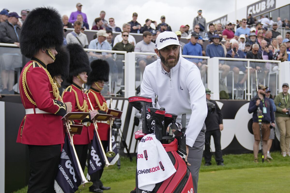 Dustin Johnson of the United States prepares to play from the first tee during the first round of the inaugural LIV Golf Invitational at the Centurion Club in St. Albans, England, Thursday, June 9, 2022. (AP Photo/Alastair Grant)