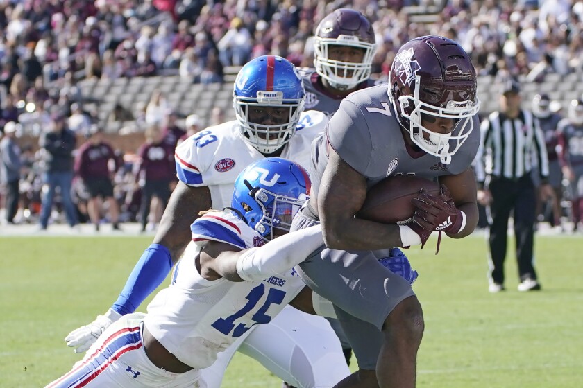 Mississippi State running back Jo'quavious Marks pulls Tennessee State defensive back Kenyon Garlington into the end zone.