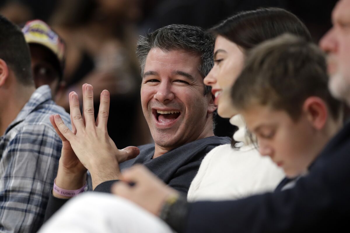 Uber founder Travis Kalanick smiles while watching an NBA basketball game between the Los Angeles Lakers and the Miami Heat Friday, Nov. 8, 2019, in Los Angeles.