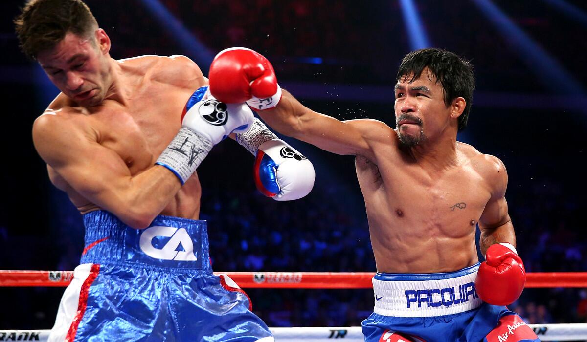 Manny Pacquiao sends Chris Algieri reeling with an overhand right during their bout Saturday night in Macao.