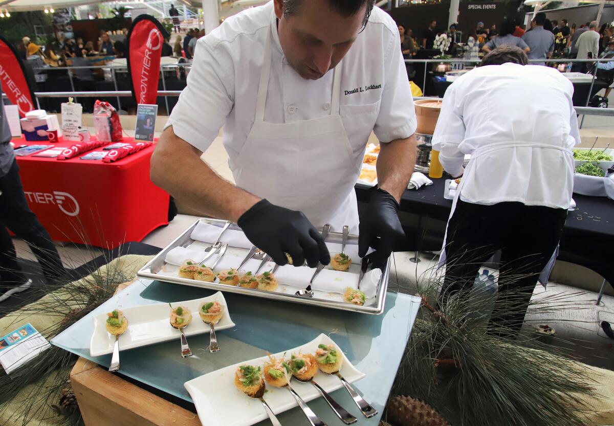 Chef Donald L. Lockhart from Terra Restaurant prepares a salmon confit on a phyllo dough nest during the Taste of Laguna.