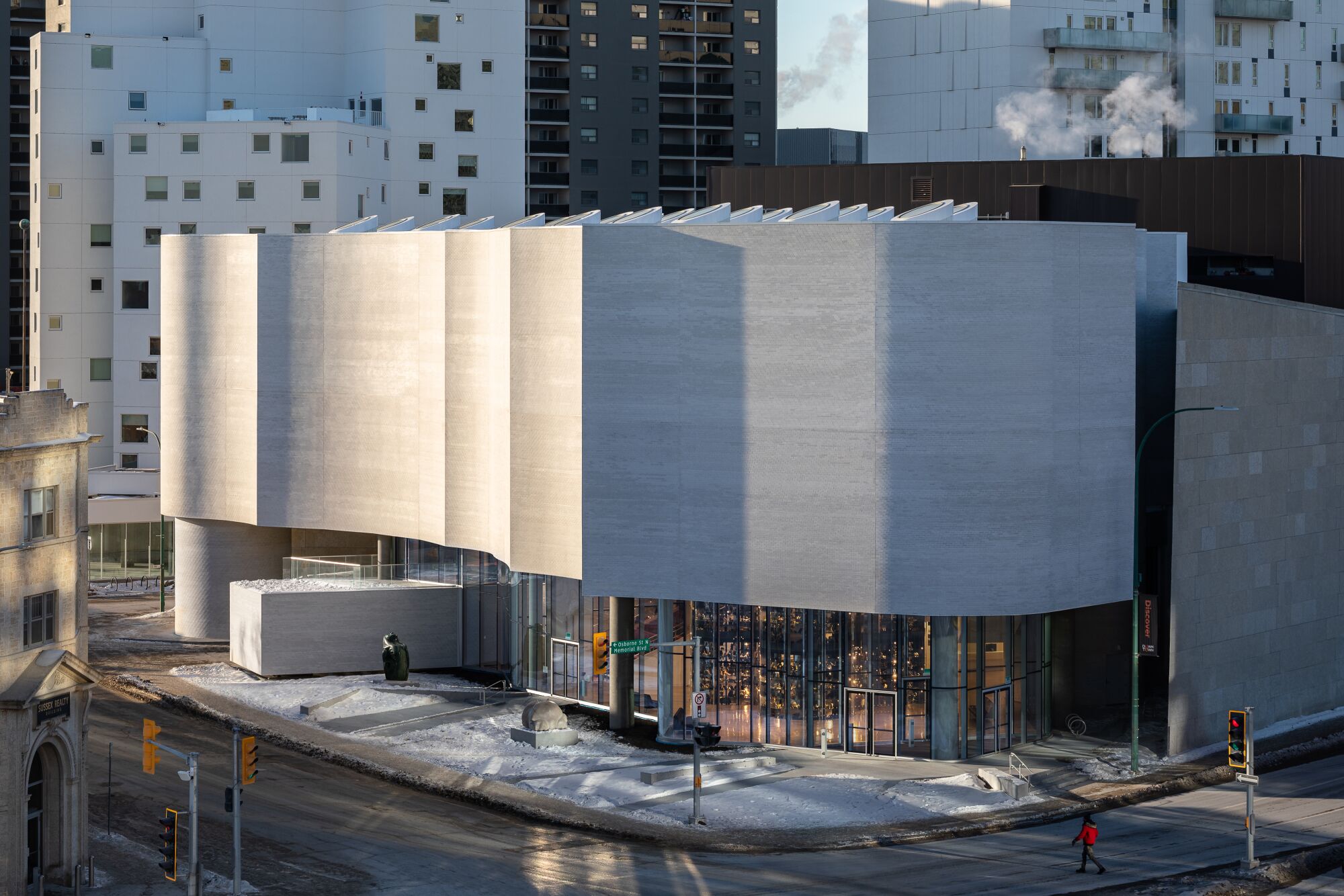 Afternoon light reflects off the rippling white facade of Qaumajuq, an important center for Inuit art