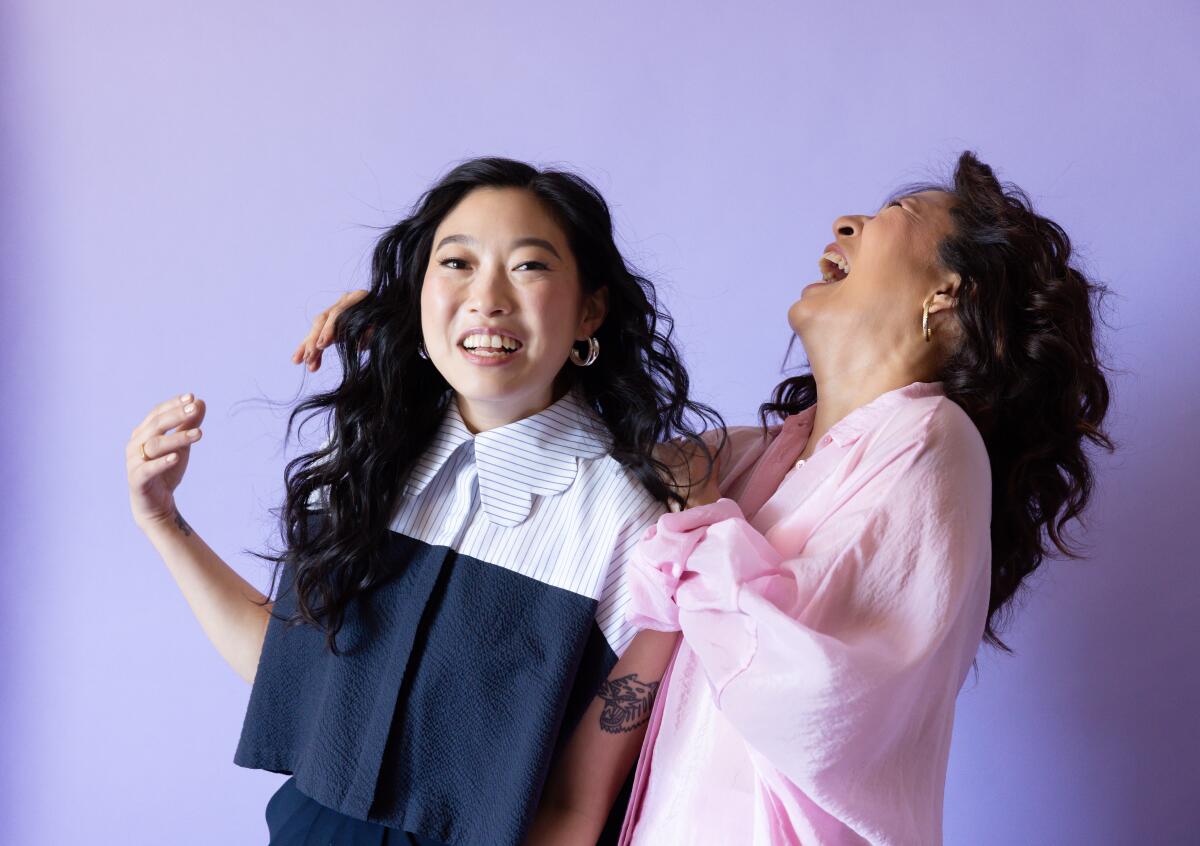 Awkwafina and Sandra Oh laugh during a portrait session.