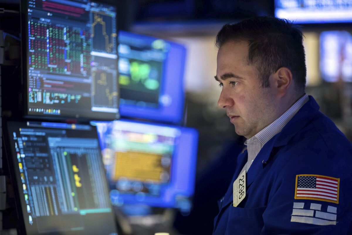 In this photo provided by the New York Stock Exchange, specialist Gennaro Saporito works at his post on the trading floor, Friday, Feb. 11, 2022. Stocks are falling sharply again on Friday, and this time Treasury yields are joining in the latest swoon for Wall Street. (Courtney Crow/New York Stock Exchange via AP)