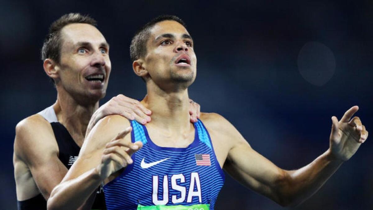 Matthew Centrowitz of the United States reacts with Nicholas Willis of New Zealand after winning the gold medal in the men's 1500-meter final.