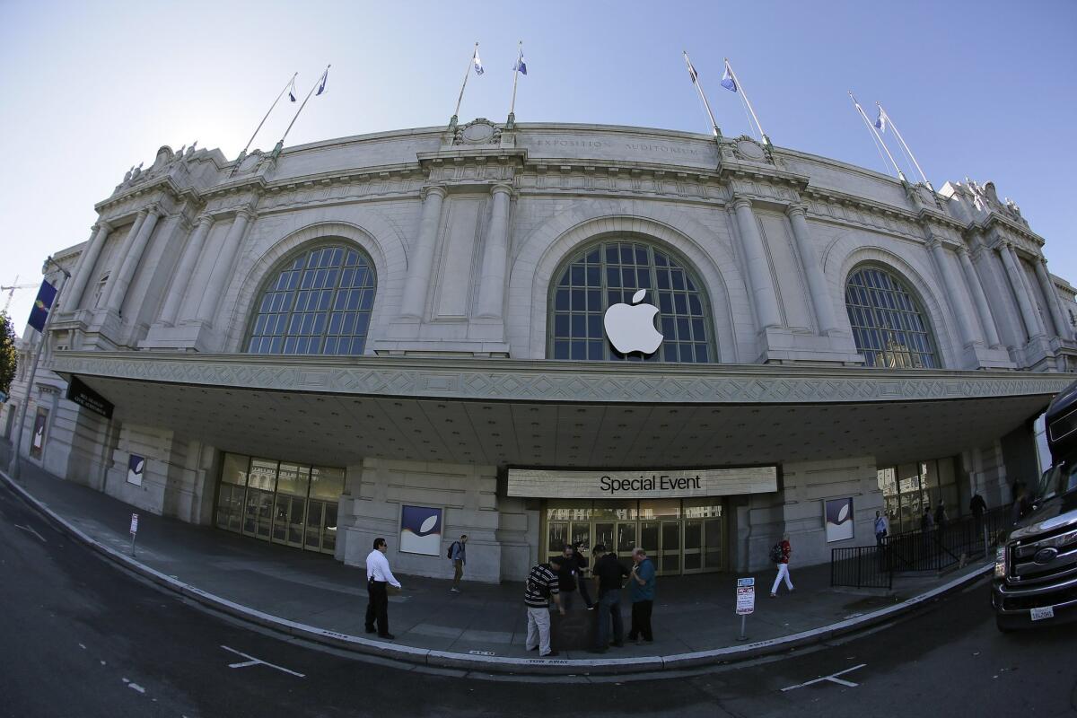 A crew works outside the Bill Graham Civic Auditorium as preparations continue for the Apple product announcements in San Francisco.