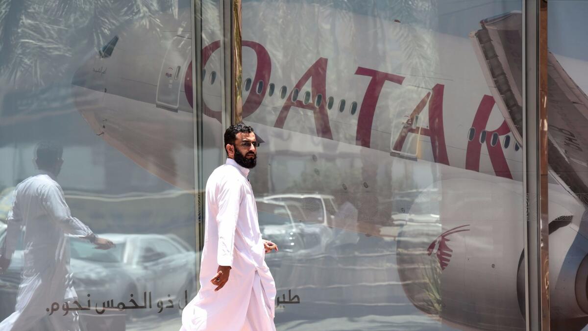 A man walks past the Qatar Airways branch on June 5, 2017, in the Saudi capital, Riyadh, after it suspended all flights to Saudi Arabia amid a severing of relations between major Persian Gulf states.