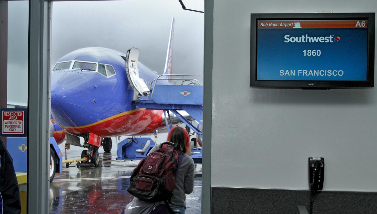 A passenger heads out to the board the first Southwest Airlines Burbank-to-San Francisco flight on January 6, 2016.