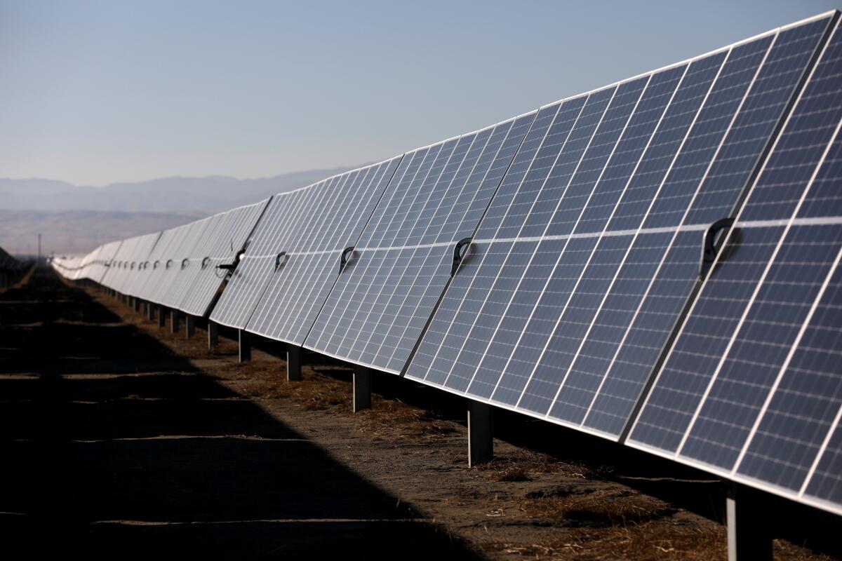 Solar panels stretch across the desert.
