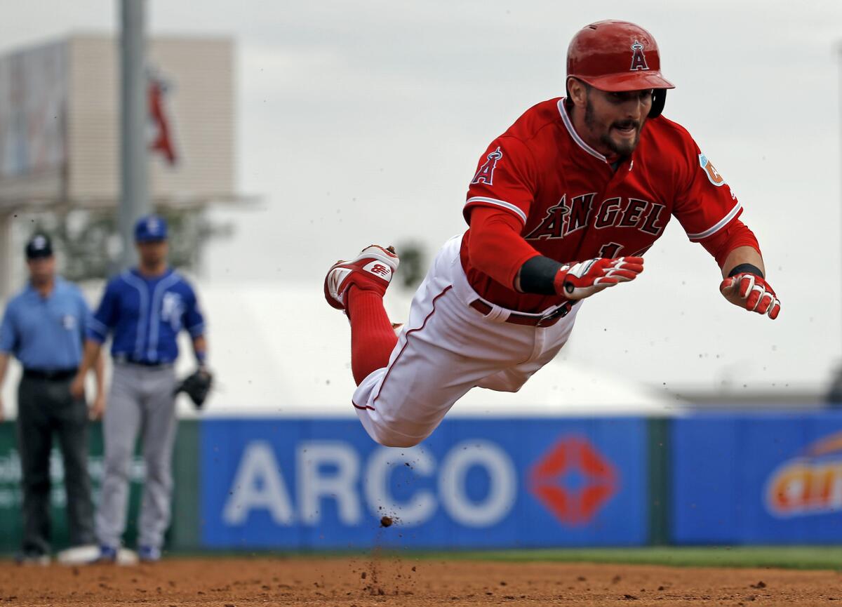 Angels second baseman Johnny Giavotella makes a head first dive for a triple during the second inning of a spring training game on Mar. 6.