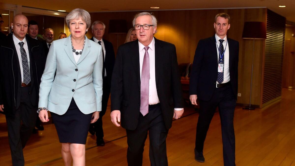 British Prime Minister Theresa May and European Commission President Jean-Claude Juncker, second from right, arrive for a meeting at the European Commission in Brussels on Dec. 8, 2017.
