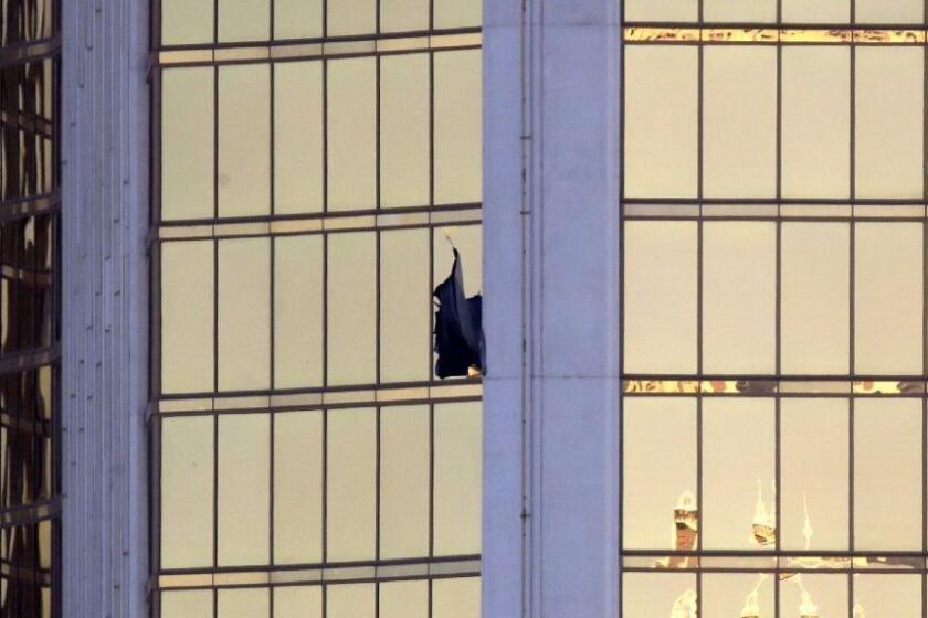 A broken window is seen at the Mandalay Bay resort and casino Monday, Oct. 2, 2017, on the Las Vegas Strip following a deadly shooting at a music festival in Las Vegas. (AP Photo/Chris Carlson)