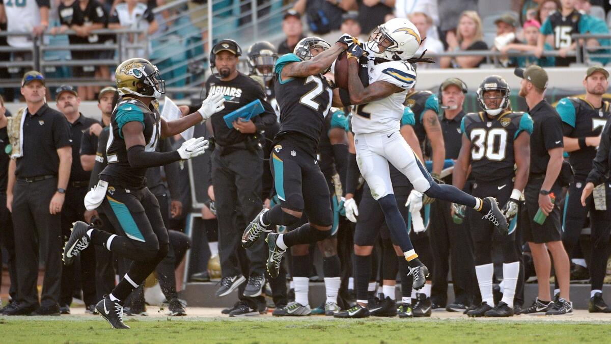 Jacksonville Jaguars cornerback A.J. Bouye, left, intercepts a pass intended for Chargers receiver Travis Benjamin in overtime.