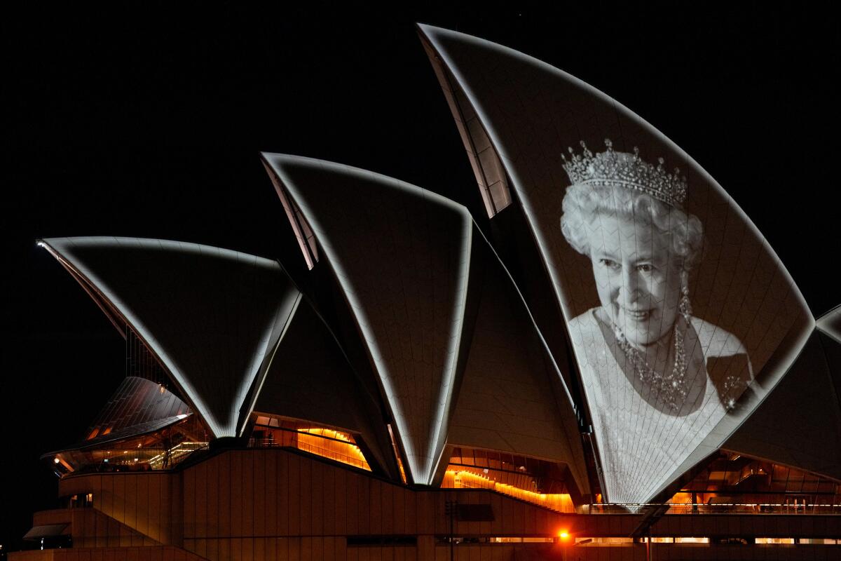 The Sydney Opera House is illuminated with a portrait of Queen Elizabeth II in Sydney, Australia, Friday, Sept. 9, 2022. Queen Elizabeth II, Britain's longest-reigning monarch and a rock of stability in a turbulent era for her country and the world, died Thursday, Sept. 8 after 70 years on the throne. She was 96. (AP Photo/Mark Baker)