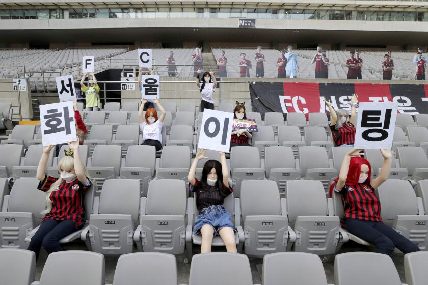 In this May 17, 2020 photo, Cheering mannequins are installed at the empty spectators' seats before the start of soccer match between FC Seoul and Gwangju FC at the Seoul World Cup Stadium in Seoul, South Korea. A South Korean professional soccer club has apologized after being accused of putting sex dolls in empty stands during a match Sunday in Seoul. In a statement, FC Seoul expressed "sincere remorse" over the controversy, but insisted that it used mannequins, not sex dolls, to mimic a home crowd during its 1-0 win over Gwangju FC at the Seoul World Cup stadium. The signs read " Go! FC Seoul." (Ryu Young-suk/Yonhap via AP)