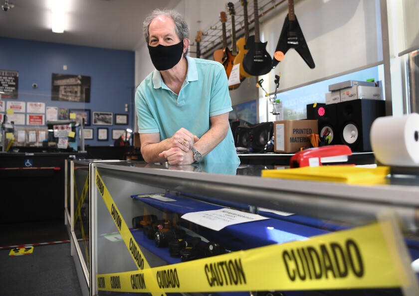 Manager Danny Justman stands inside Pawnmart business in Norwalk.