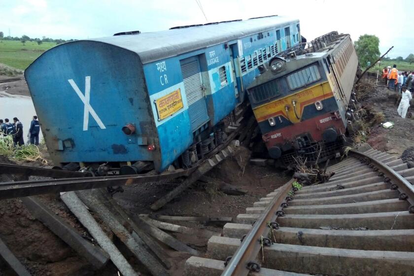 Two passenger trains derailed after being hit by flash floods on a bridge in central India, killing at least 24 people in the latest deadly accident on the nation's crumbling rail network.