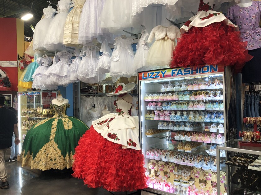 Buoyant quinceanera gowns with massive skirts frame a stall inside Plaza Fiesta.