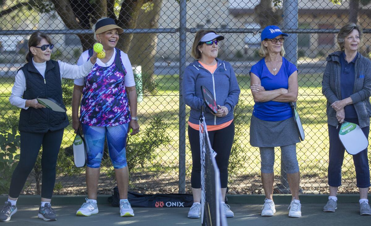 Participants watch as pro pickleball instructor Jeaney Garcia teaches a class.