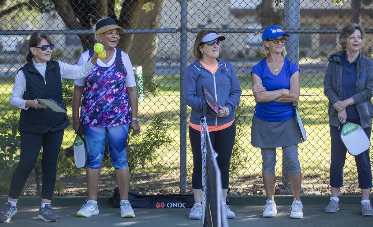 Participants watch as pro pickleball instructor Jeaney Garcia teaches a class. 