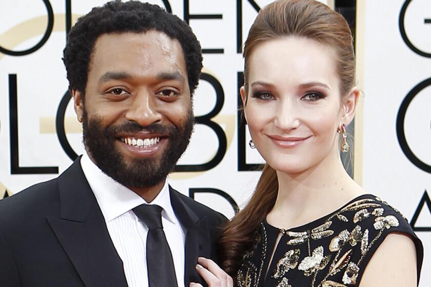 Chiwetel Ejiofor and girlfriend Sari Mercer arrive at the 71st Golden Globe Awards show at the Beverly Hilton on Sunday.