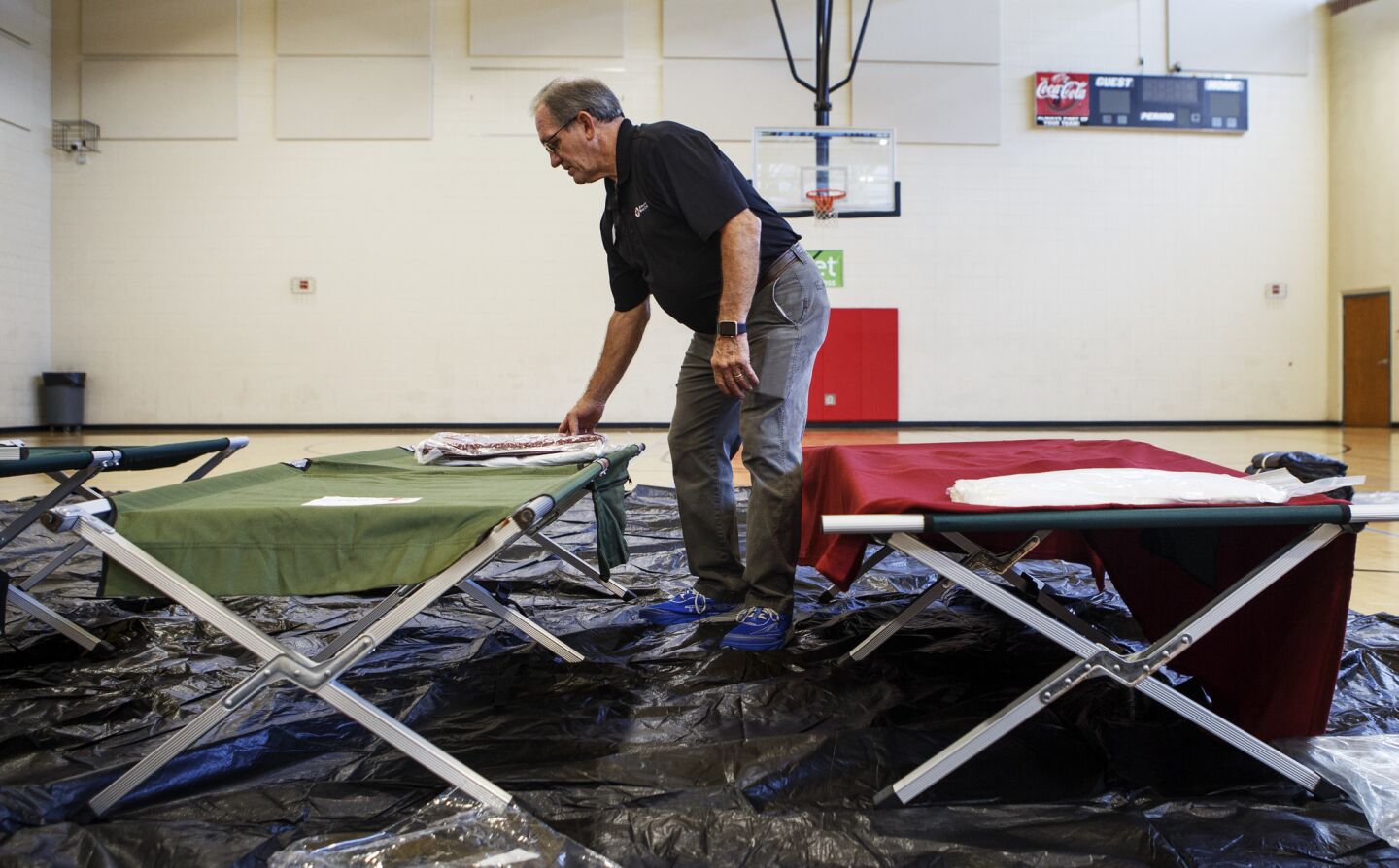 Southeast Tennessee American Red Cross Disaster Program Manager Jerry Wang preps cots in the gym at the Brainerd Youth and Family Development Center on Thursday, Sept. 13, 2018 in Chattanooga, Tenn. The Hamilton County Office of Emergency Management, American Red Cross and other organizations are joining to open and operate a shelter at the Brainerd Youth & Family Development Center for coastal residents fleeing Hurricane Florence, according to a news release.