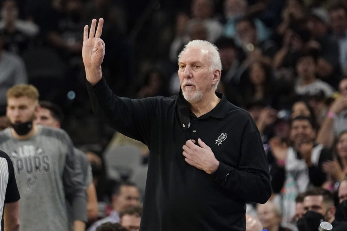 San Antonio Spurs head coach Gregg Popovich signals to players during the first half of an NBA basketball game against the Sacramento Kings, Thursday, March 3, 2022, in San Antonio. (AP Photo/Eric Gay)