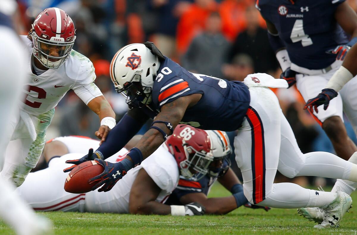 Auburn's Tre' Williams recovers a fumble by Alabama's Jalen Hurts on Nov. 25, 2017, at Jordan Hare Stadium.