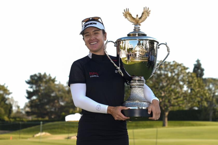 Hannah Green holds up the championship trophy after winning the LPGA's JM Eagle LA Championship golf tournament at Wilshire Country Club, Sunday, April 28, 2024, in Los Angeles. (AP Photo/Ashley Landis)