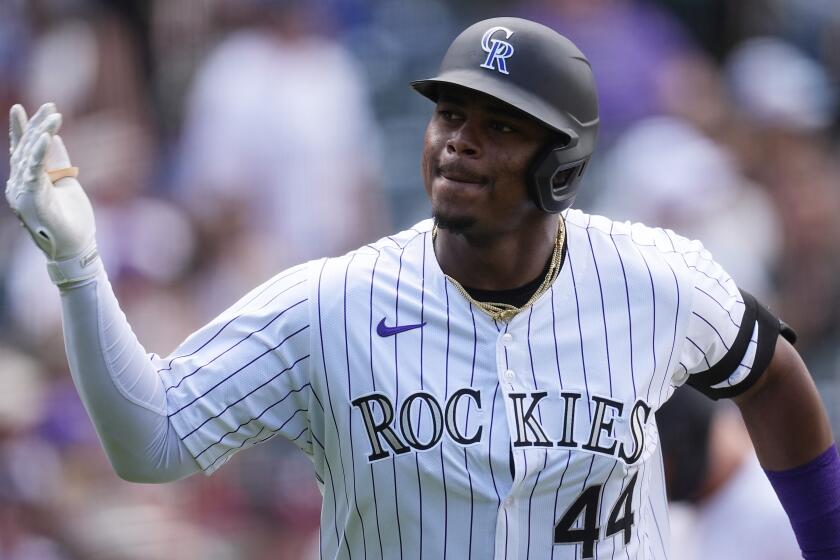 Colorado Rockies' Elehuris Montero gestures to the dugout as he heads up the first-base line after hitting a two-run home run off San Diego Padres starting pitcher Randy Vásquez in the third inning of a baseball game Thursday, April 25, 2024, in Denver. (AP Photo/David Zalubowski)