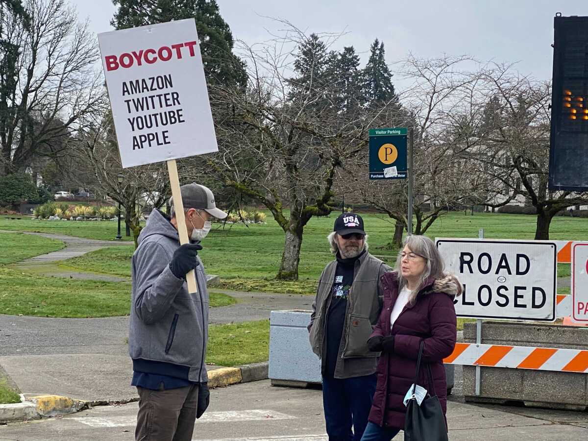 Jeff Koch (left) of Federal Way, Wash., protested in support of President Trump this week in Olympia.