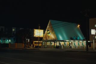 An A-frame fried fish restaurant lit up at night