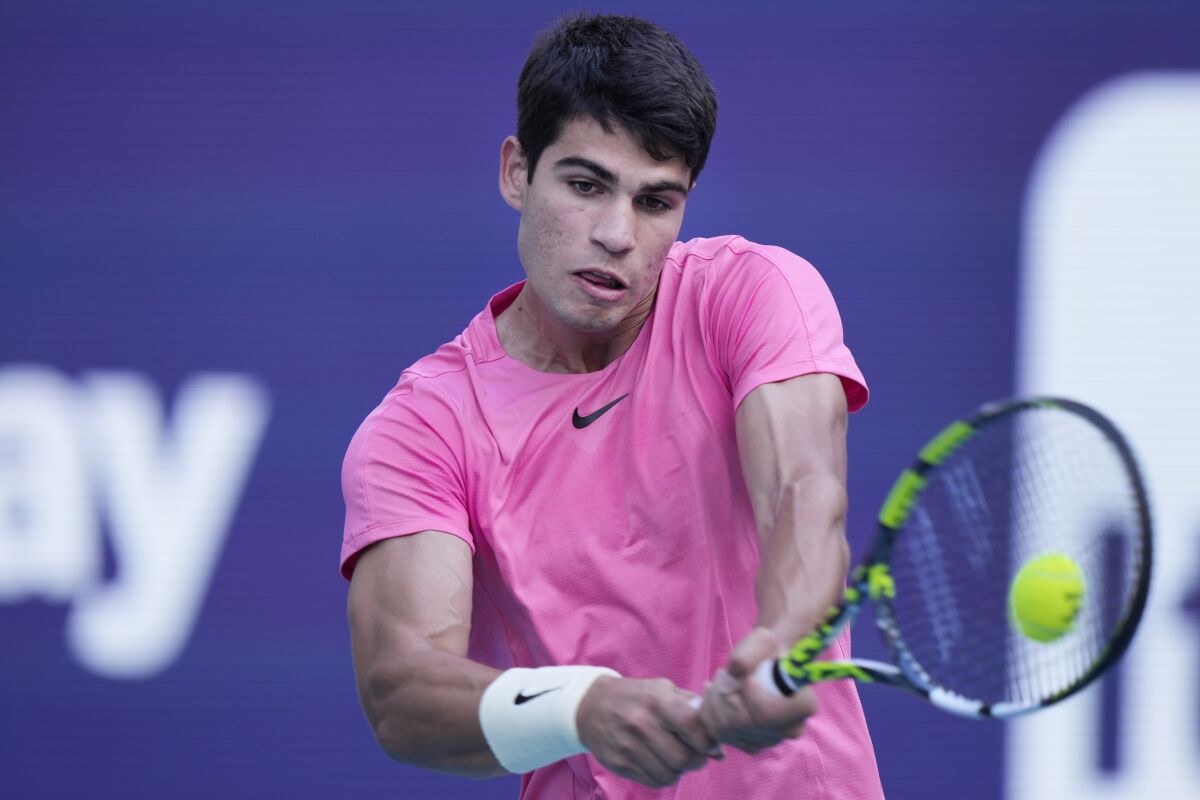 Carlos Alcaraz, of Spain, returns a shot from Facundo Bagnis, of Argentina, during the Miami Open tennis tournament, Friday, March 24, 2023, in Miami Gardens, Fla. (AP Photo/Wilfredo Lee)