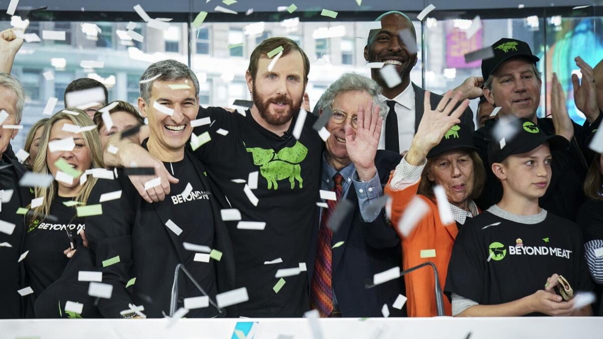 Beyond Meat CEO Ethan Brown, center, celebrates with guests after ringing the opening bell at Nasdaq MarketSite in New York on Thursday.