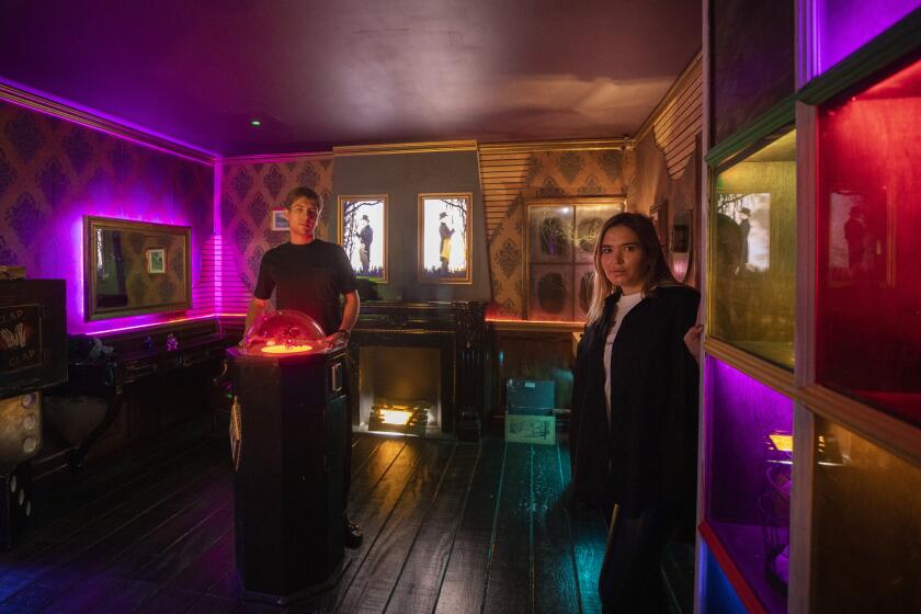 A man and a woman standing inside a colorful room