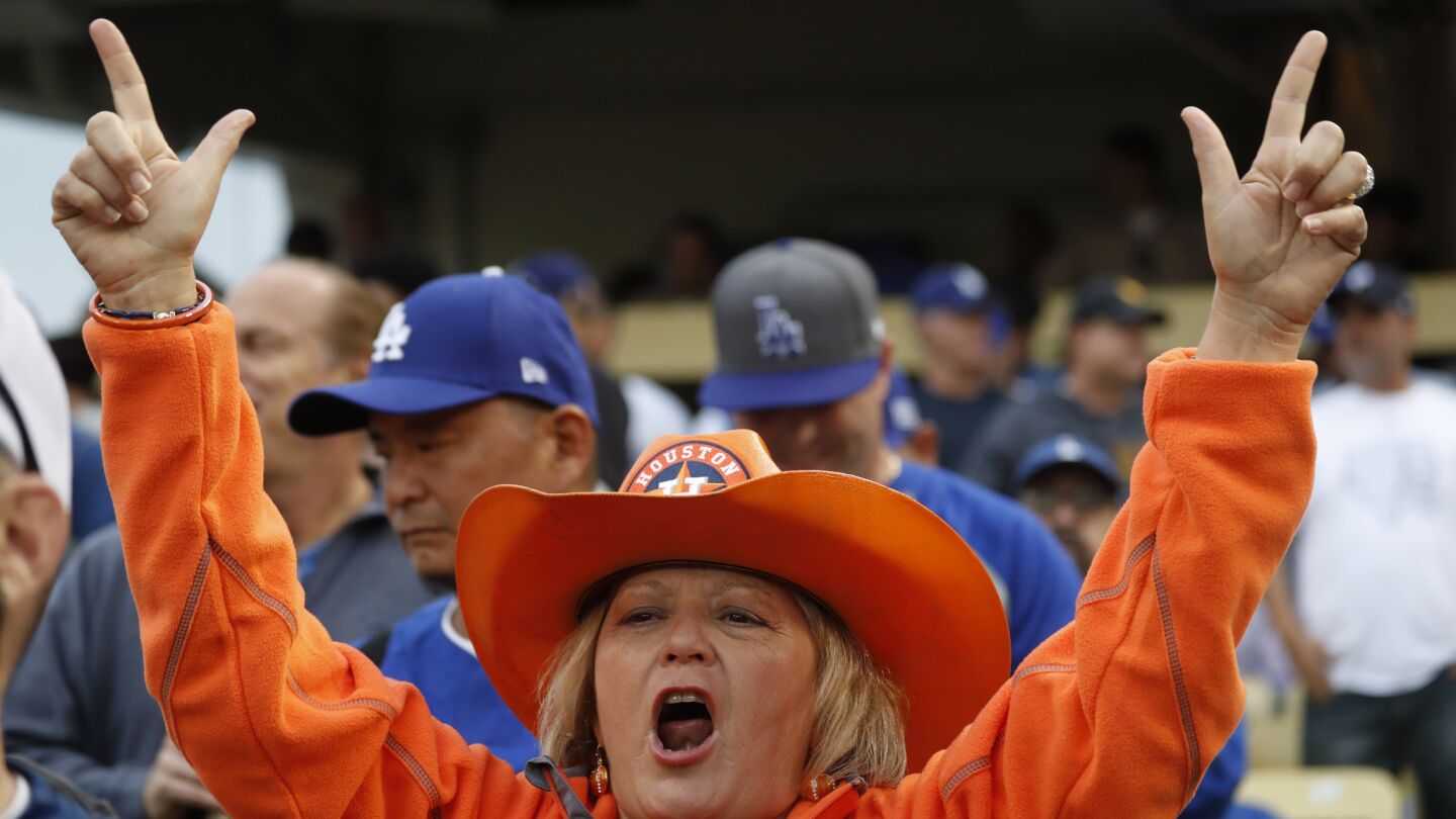 An Astros fan cheers on her team as the Dodgers play the Astros in Game 6.