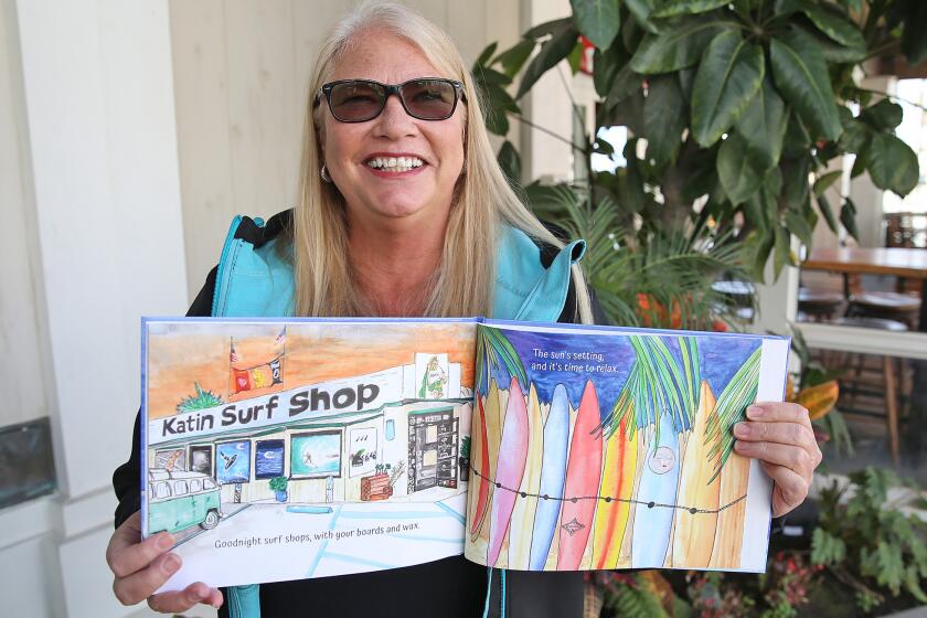 Huntington Beach author Toni Haas shows a few of her favorite pages in her new children's book, "Goodnight Surf City," which highlights iconic locations of her hometown Huntington Beach. Her book launch event is next month at Pacific City, in conjunction with Read Across America.