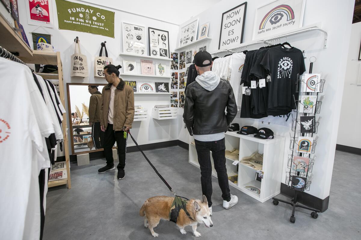 Jon Yu, left, and Dusty Alexander check out vendors' goods at Collective2one9 on Nov. 9.