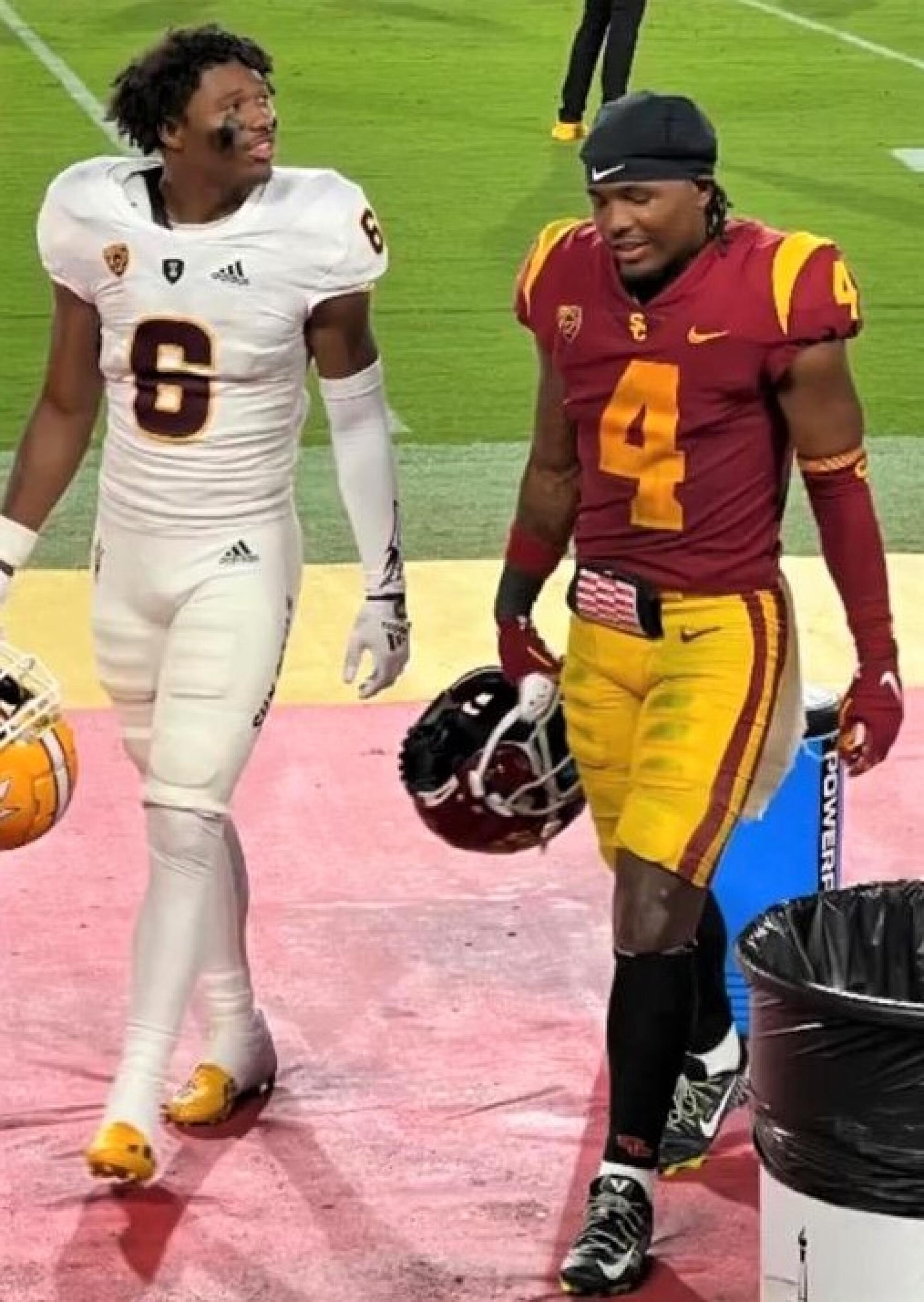 Brothers Macen and Max Williams walk off the field together following the ASU-USC game in 2022.