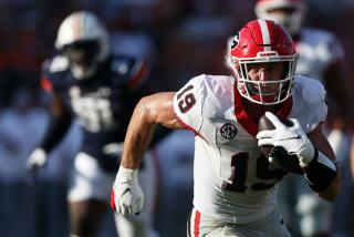 FILE - Georgia tight end Brock Bowers (19) carries the ball after a reception during the second half of an NCAA football game against Auburn, Saturday, Sept. 30, 2023, in Auburn, Ala. Bowers is a possible first round pick in the NFL Draft. (AP Photo/Butch Dill, File)