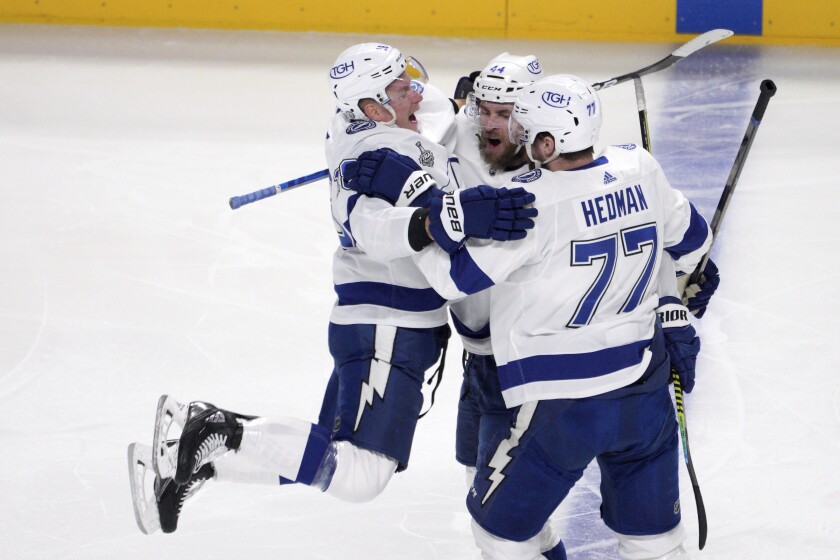 Tampa Bay's Jan Rutta celebrates with Ondrej Palat and Victor Hedman after scoring against the Montreal Canadiens.